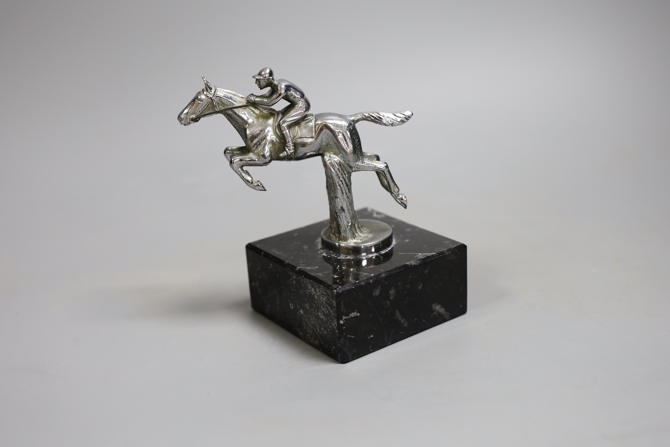A chrome plated jockey car mascot on marble base, 14cm tall